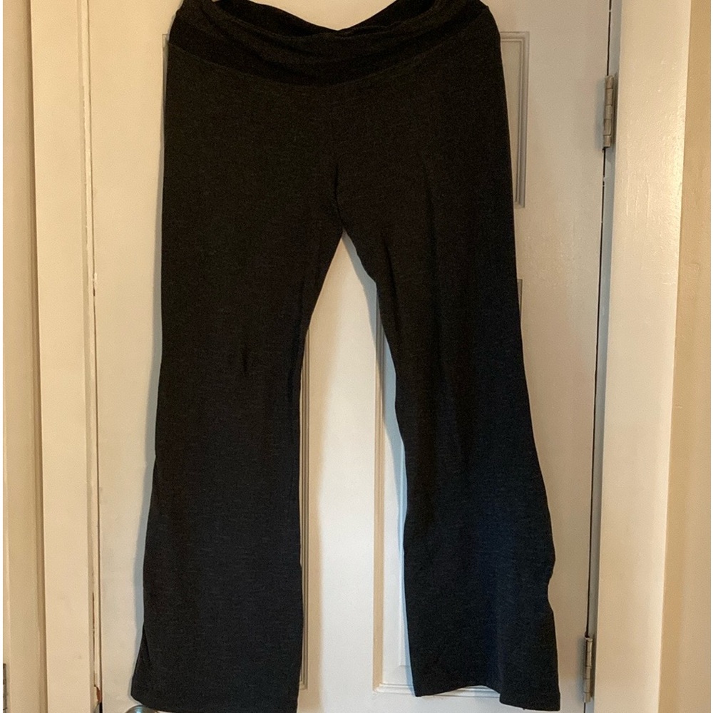 Lululemon mid-rise wide leg black yoga pants with discrete brown lines.